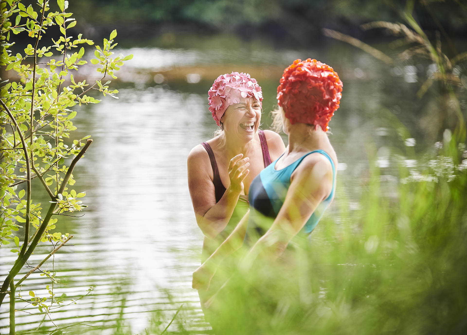 Two ladies laughing in a rural river
