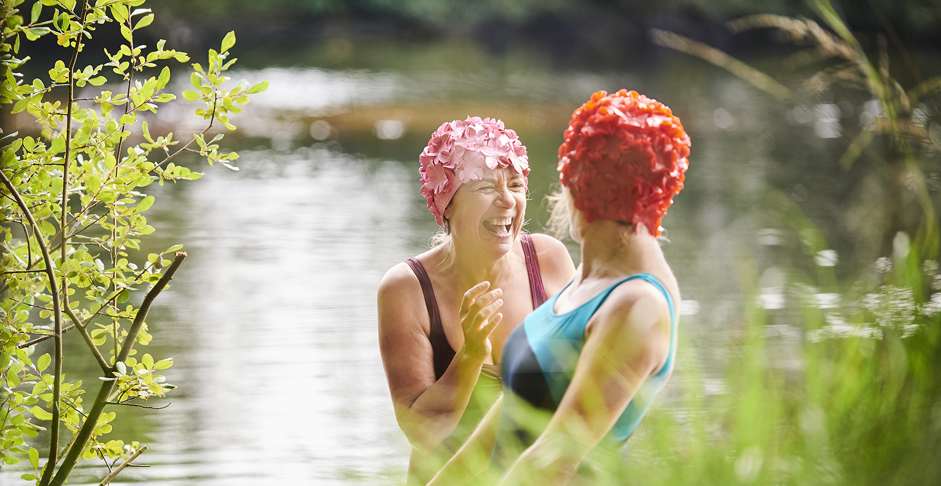 Two ladies laughing in a rural river