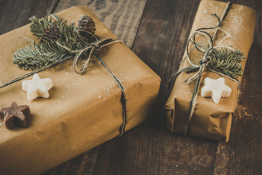 Christmas presents wrapped in brown paper with stars, and decorations