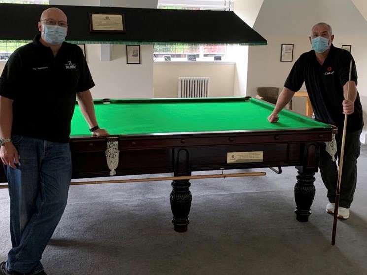 Calor Employees who refurbished the Snooker table standing by the table