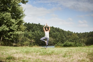 Lady doing yoga in a field
