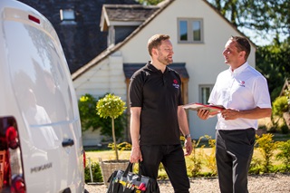 Two Calor employees talking outside of a Calor customer’s home 