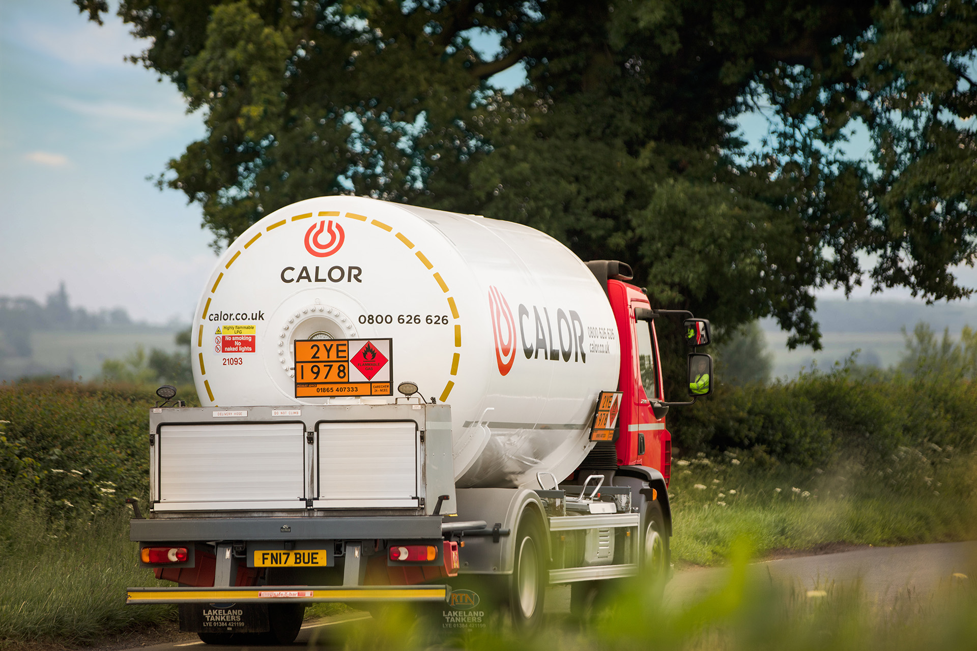An angled rear view of a Calor lorry in a rural setting