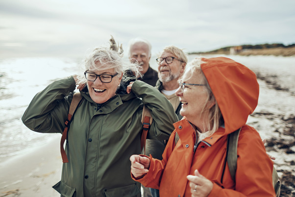 Seniors walking across a UK beach
